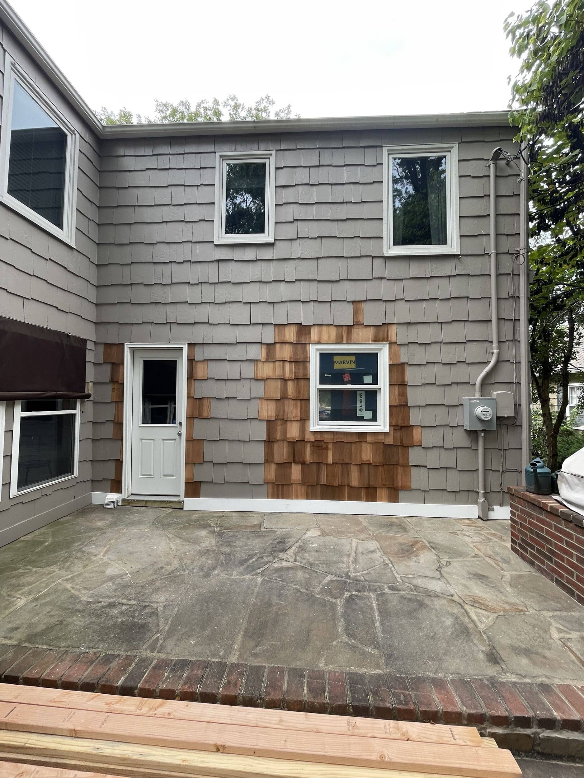 exterior view of kitchen remodel with new window and door installed 