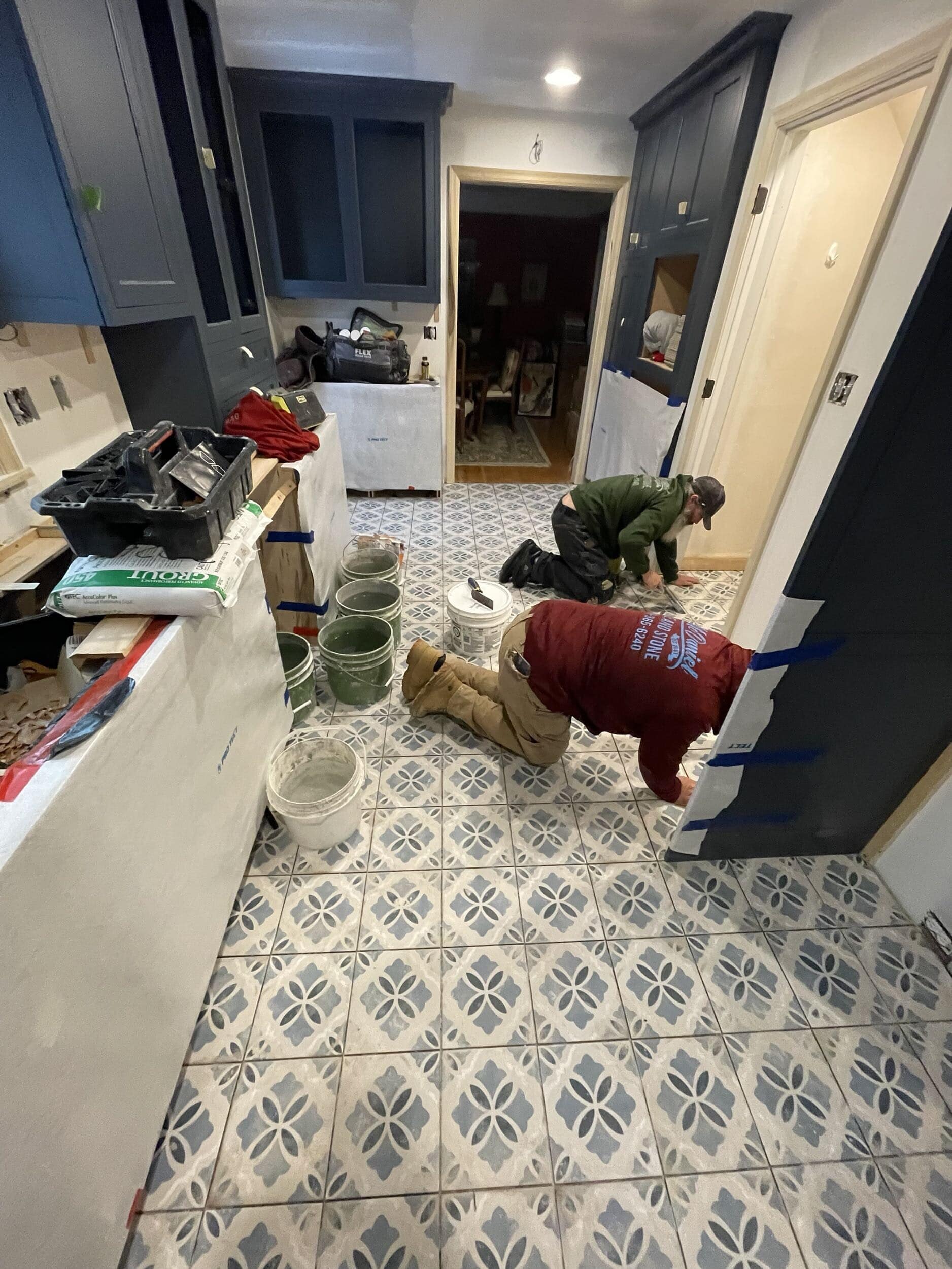 kitchen floor tile being laid in remodeling project