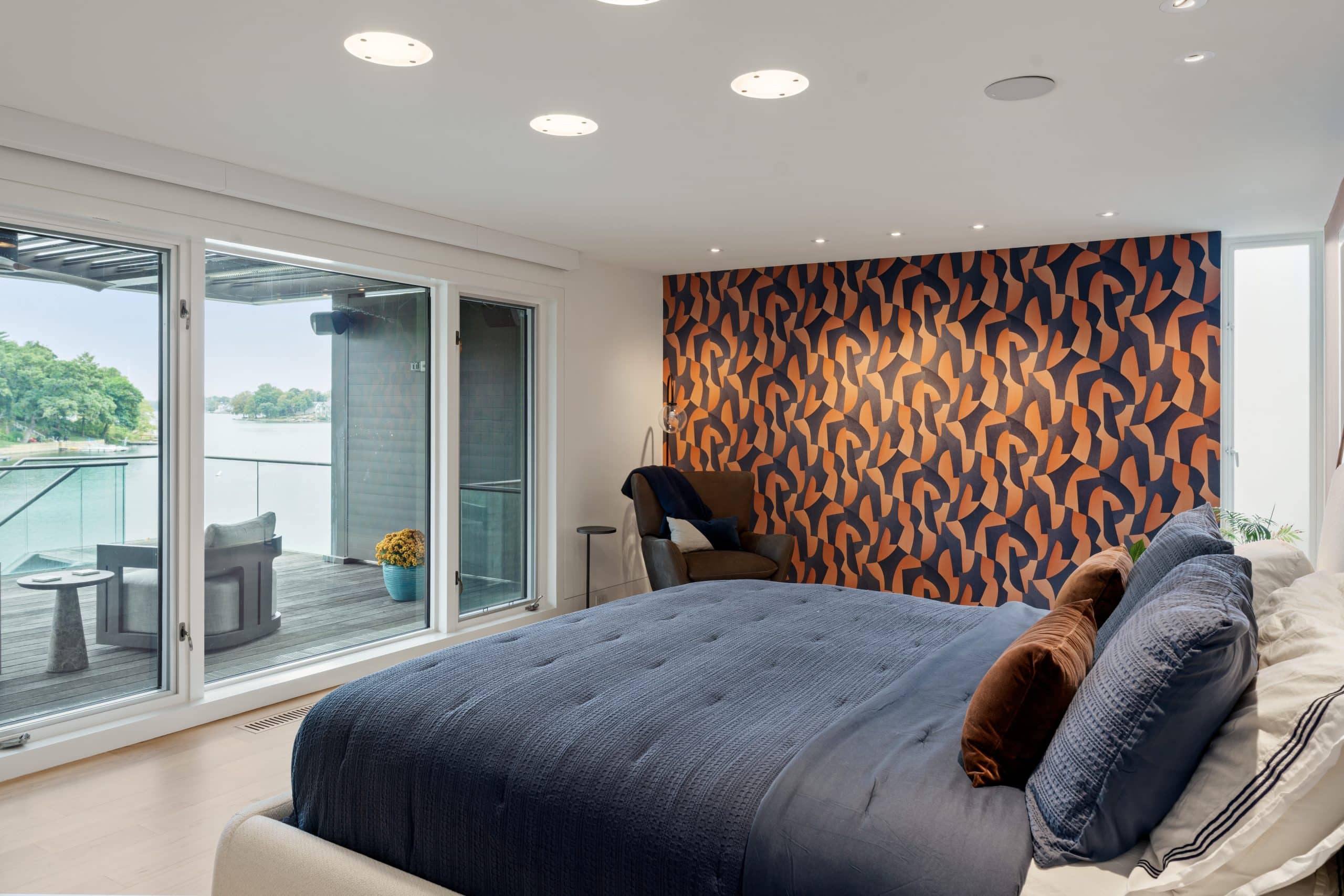 primary suite remodel with geometric pattern wallpaper and lake views