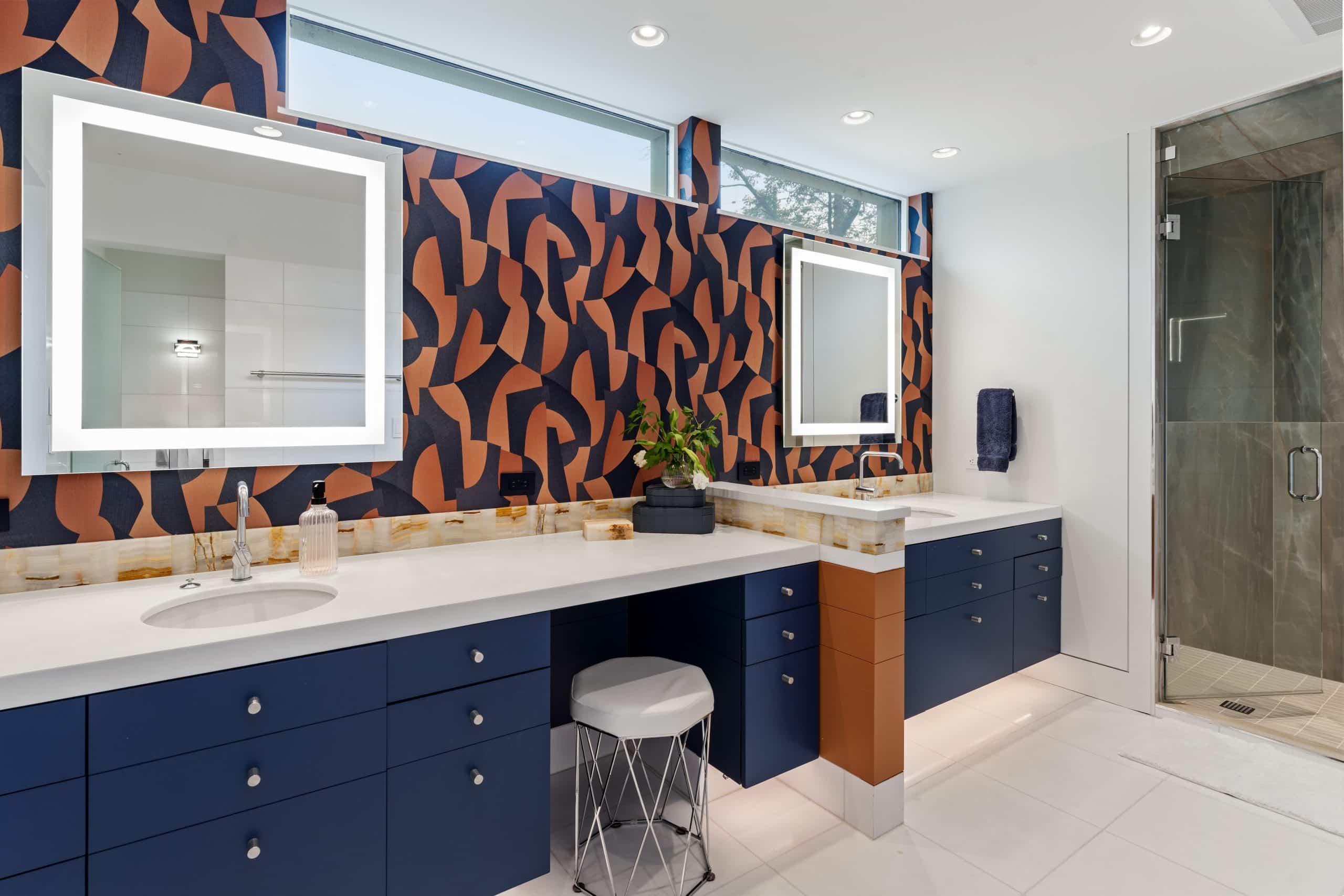primary bathroom remodel with navy cabinets and bold wallpaper and steam shower