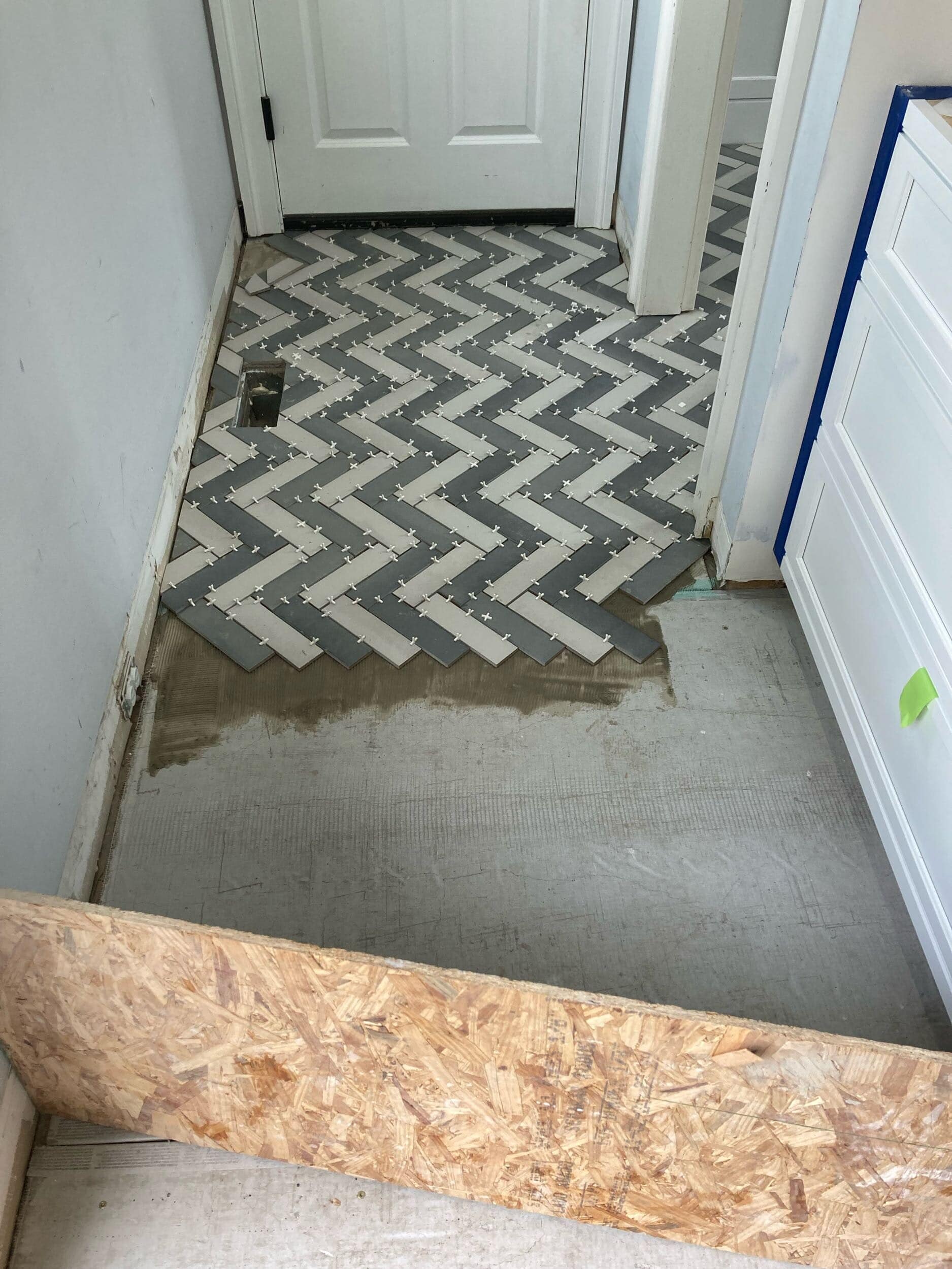 handyman team laying tile in mudroom project handyman team laying tile in mudroom project