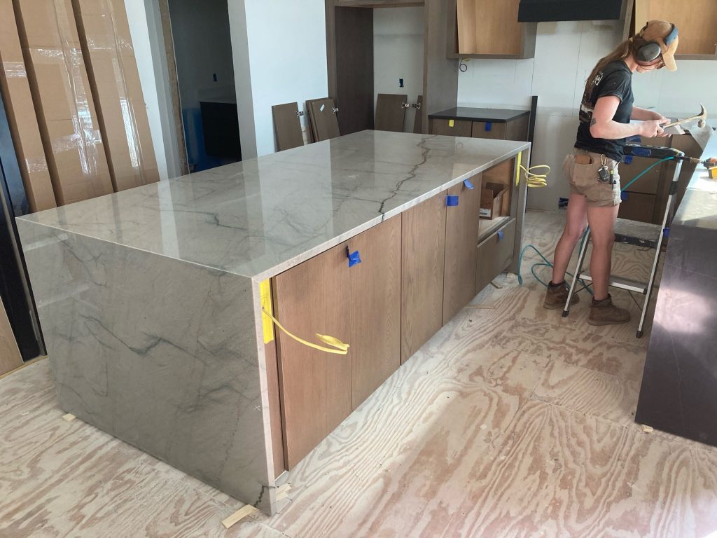 waterfall island counters installed in lake home for modern sleek contemporary feel