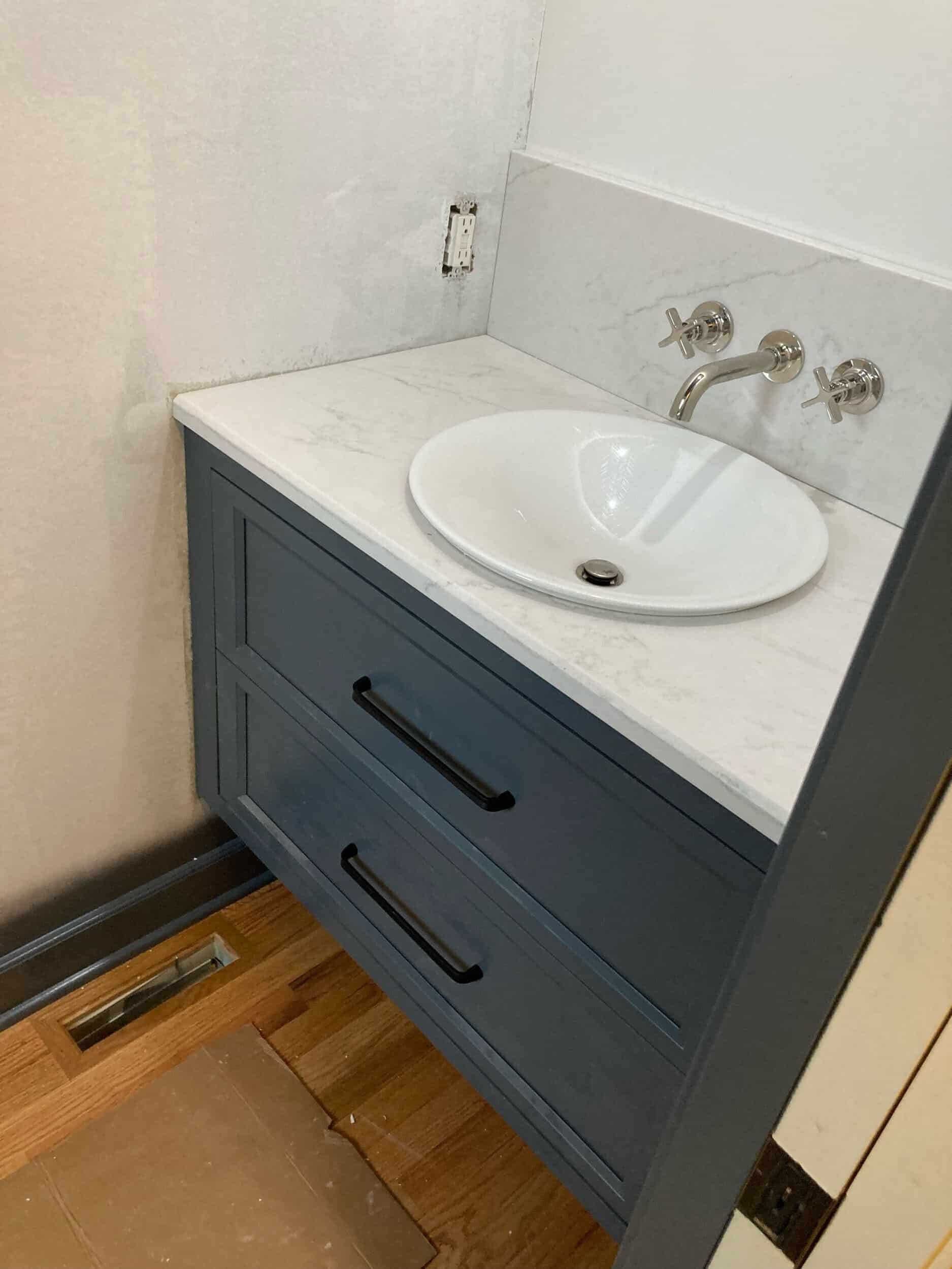 counters installed and plumbing finish in powder bath remodel