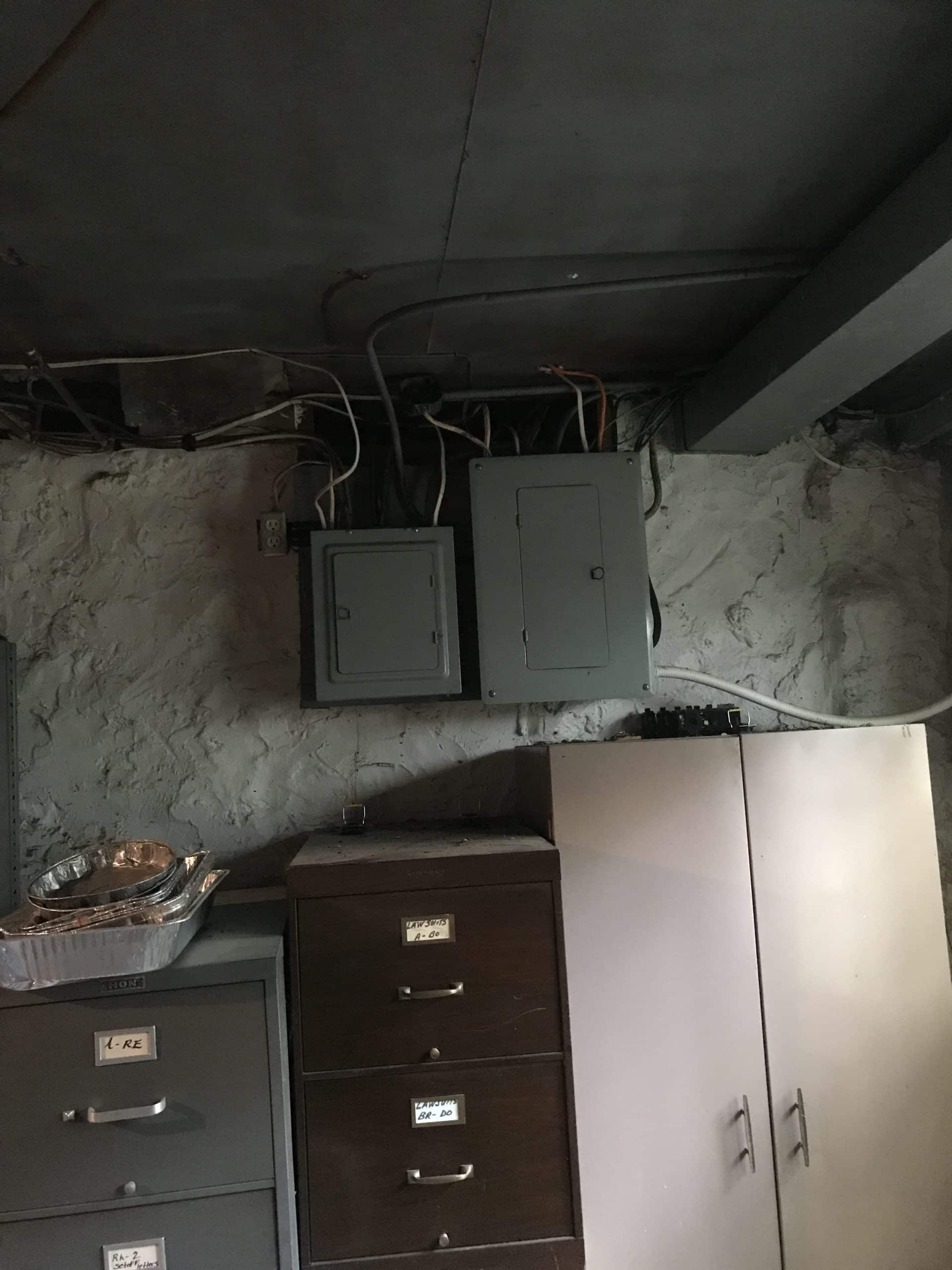 Old electrical panels in older KC home Old electrical panels and exposed wiring in the basement of an older Kansas City home.