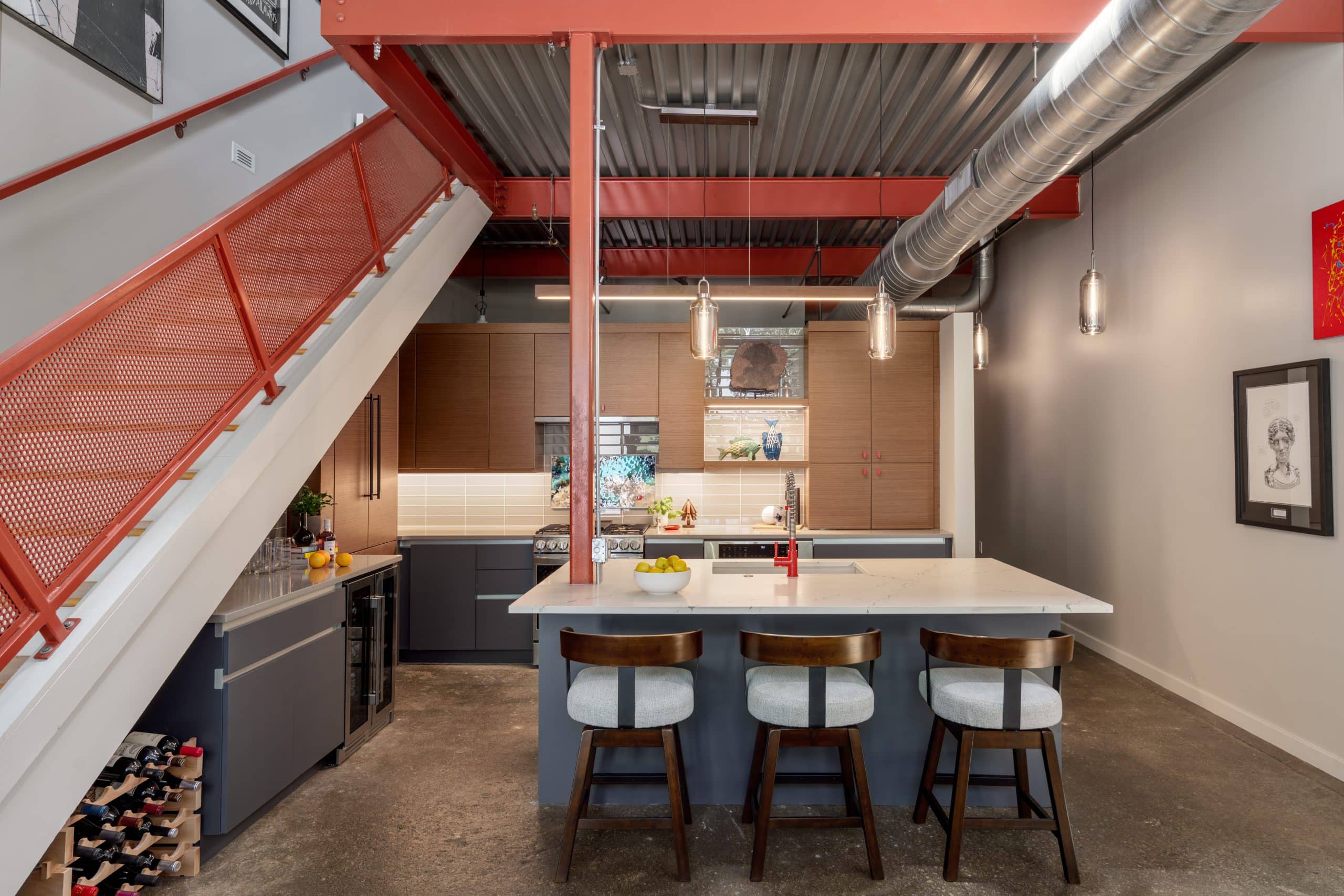 Urban contemporary kitchen remodel in a Kansas City River Market condo with warm wood cabinetry, dark cabinets and bold red accents Urban contemporary kitchen remodel in a Kansas City River Market condo with warm wood cabinetry, dark cabinets and bold red accents