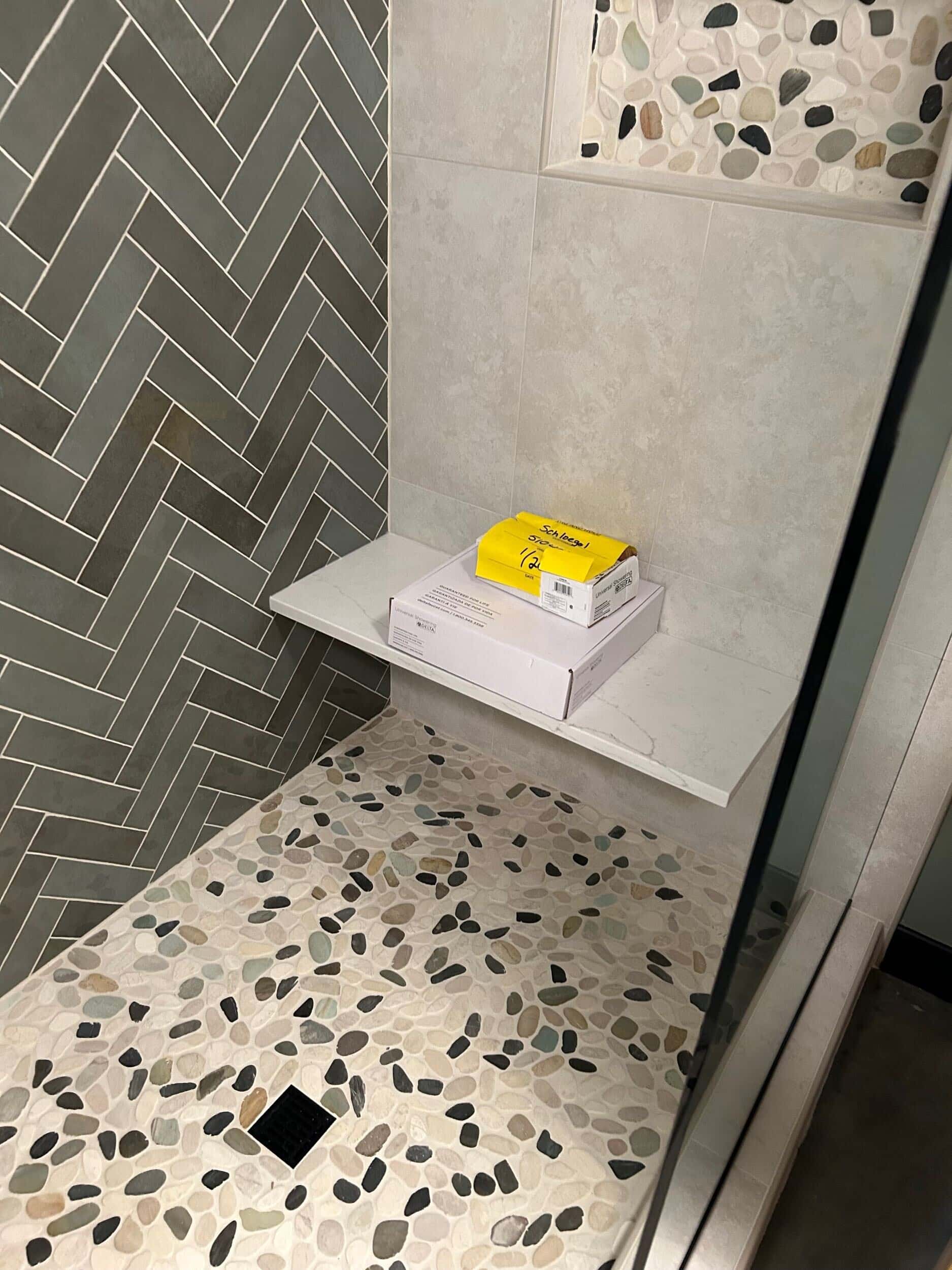 craftsmanship in pebble accent on tile floor of shower 