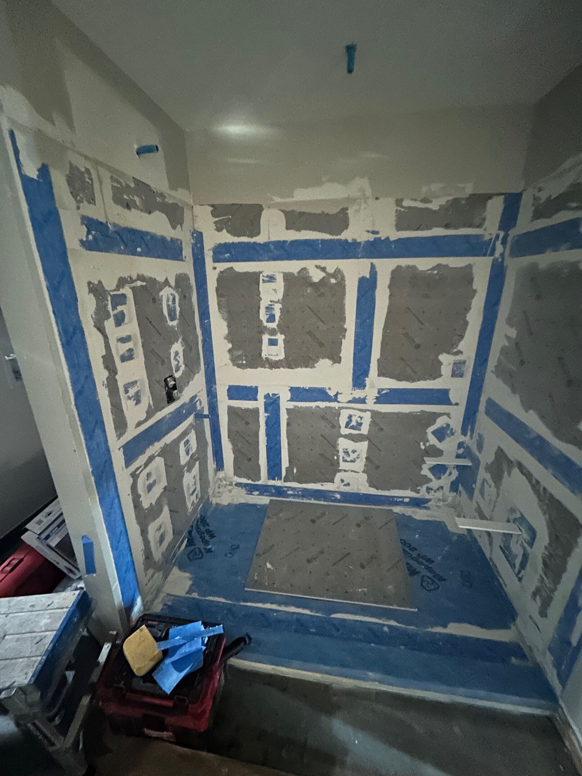 primary bathroom remodel in condo by Schloegel in the early construction phases with tile backer board on walls but not tile yet